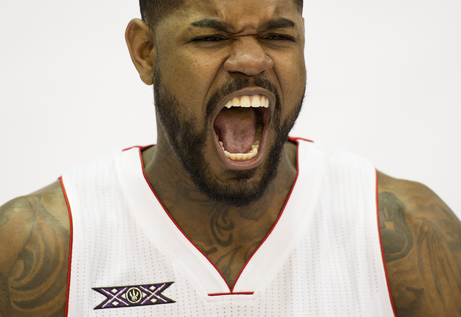 Toronto Raptors' Amir Johnson yells while posing for photos and showing off the team's 20th anniversary logo during the team's media day.